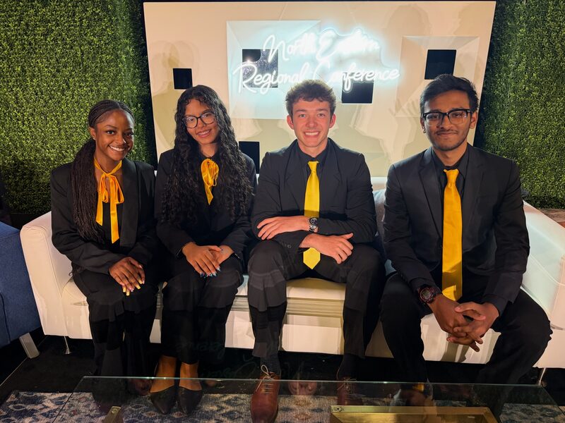 Four Legacy Point Solutions team members at a regional leadership conference