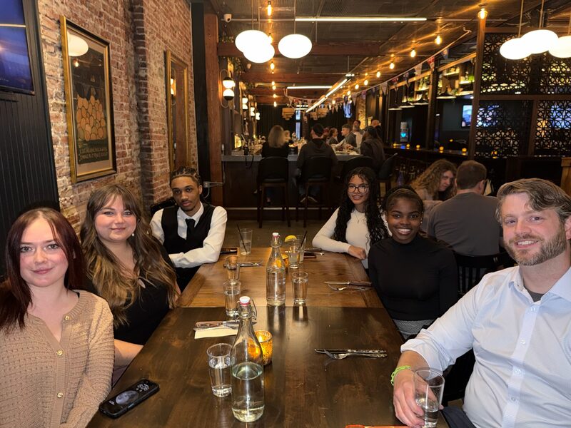 Legacy Point Solutions team members sharing a meal together at a restaurant